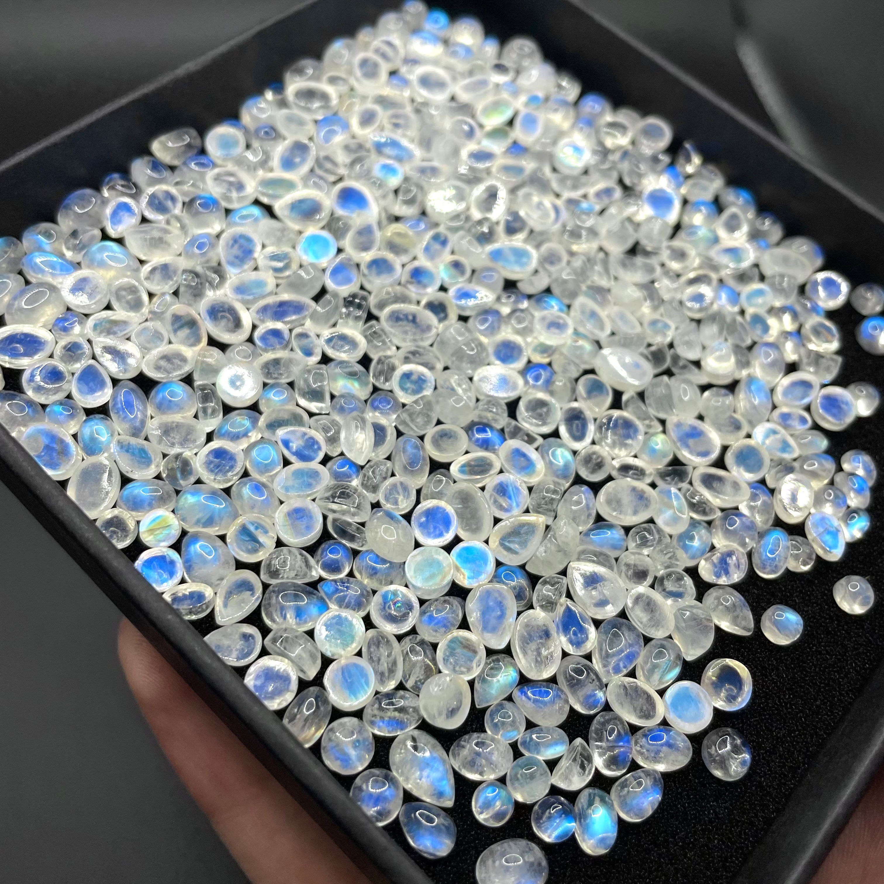Box of random assorted natural Rainbow Moonstone crystal cabochon gemstones stones
