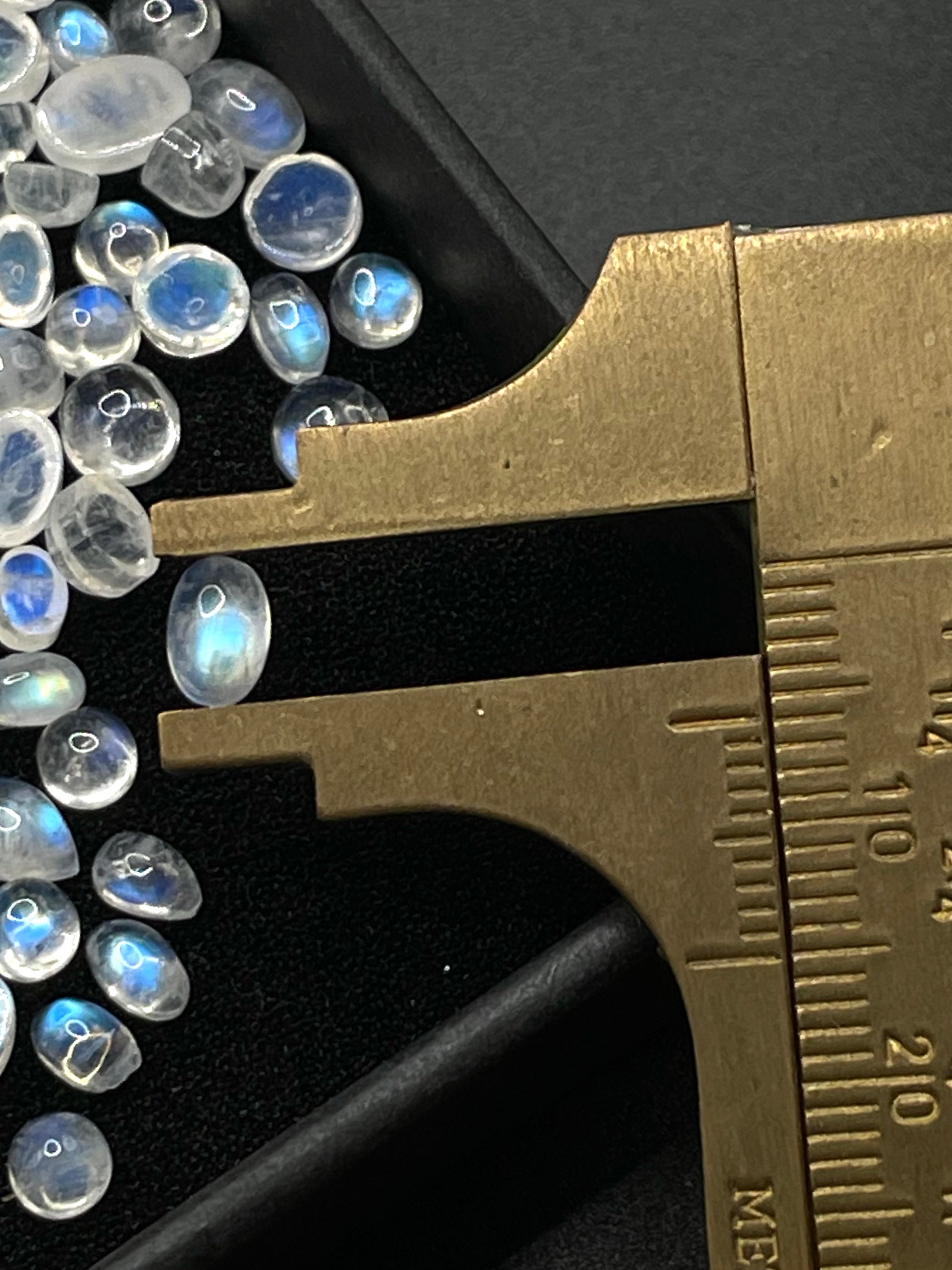 Moonstone oval crystal cabochon gemstone stone in measuring ruler