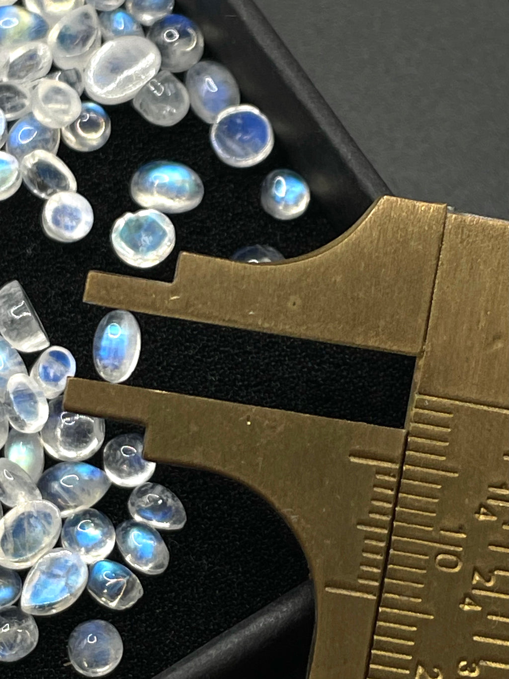 Moonstone oval crystal cabochon gemstone stone in measuring ruler