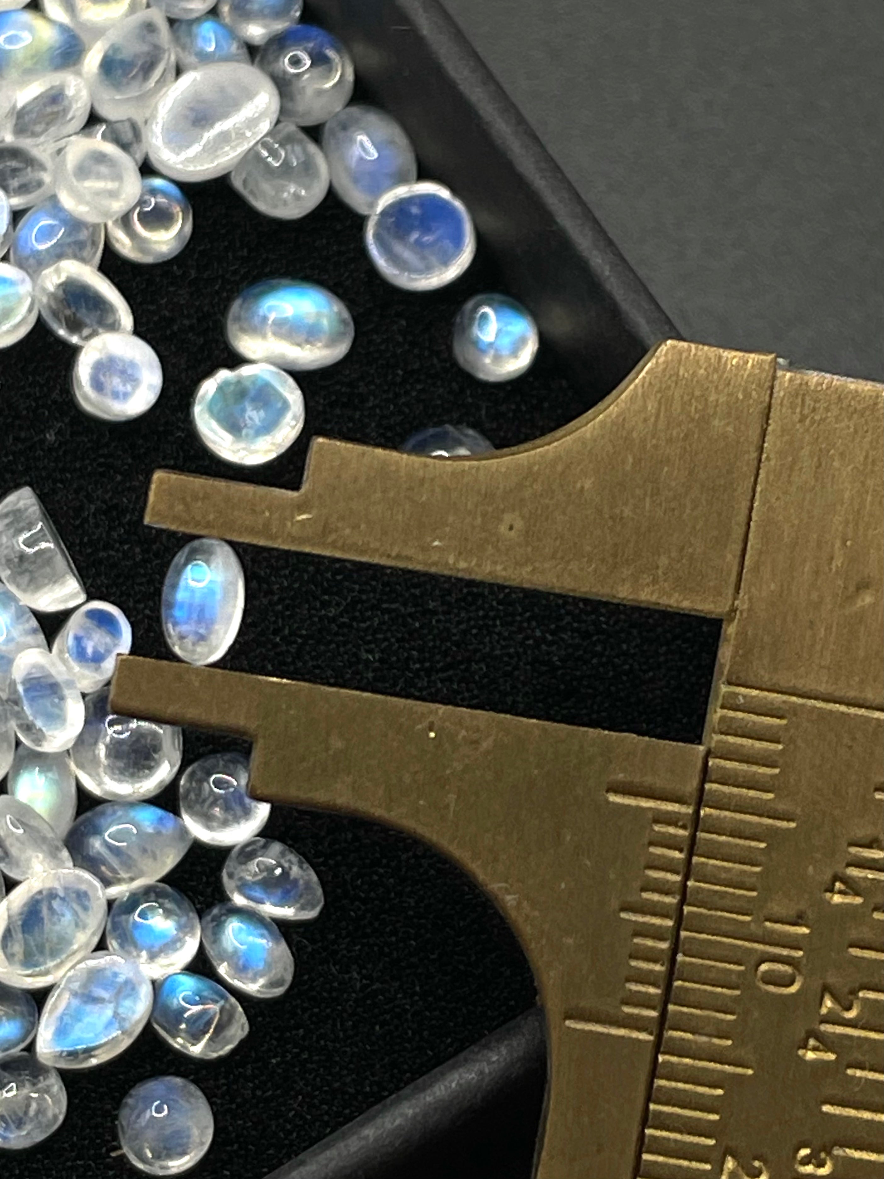 Moonstone oval crystal cabochon gemstone stone in measuring ruler